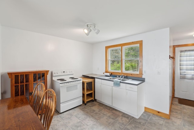 114 Birchmere Ln, Harpswell, ME 04079 - kitchen with white electric range, a sink, white cabinetry, baseboards, and stone finish floors