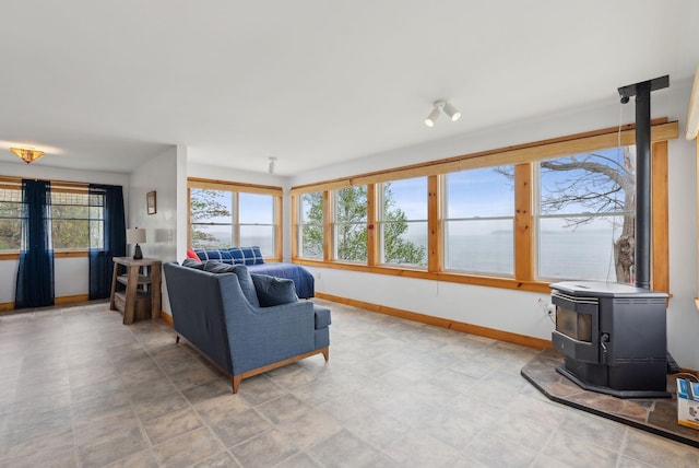 114 Birchmere Ln, Harpswell, ME 04079 - living room with a wood stove, baseboards, and a water view