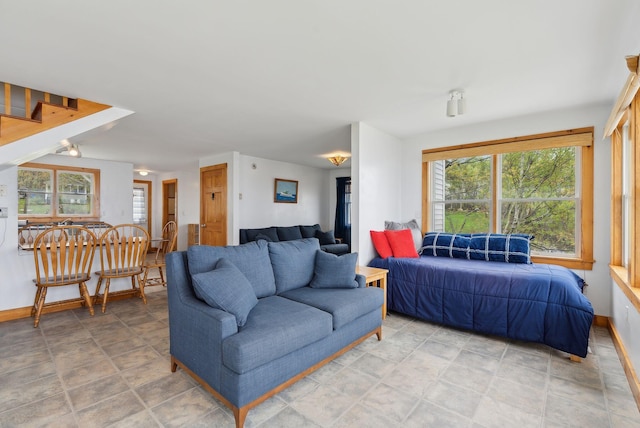 114 Birchmere Ln, Harpswell, ME 04079 - living area with healthy amount of natural light, baseboards, and stairway