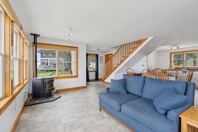 114 Birchmere Ln, Harpswell, ME 04079 - living room featuring a wood stove, stairway, and baseboards