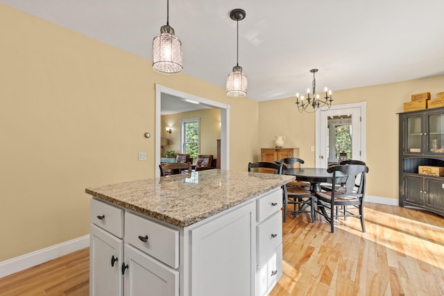 4 Geary Way, Falmouth, ME 04105 - kitchen with light wood-style flooring, baseboards, white cabinetry, and a kitchen island