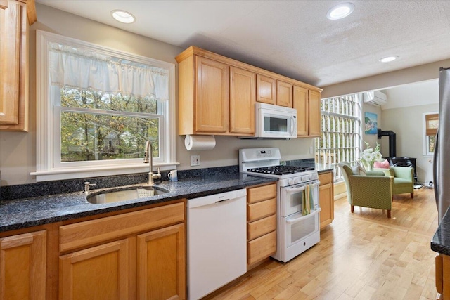 25 Sawmill Ln, Ogunquit, ME 03907 - kitchen featuring white appliances, a wall unit AC, light wood-style floors, recessed lighting, and dark stone countertops