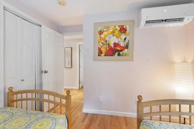 25 Sawmill Ln, Ogunquit, ME 03907 - bedroom with a wall mounted air conditioner and light wood-style floors