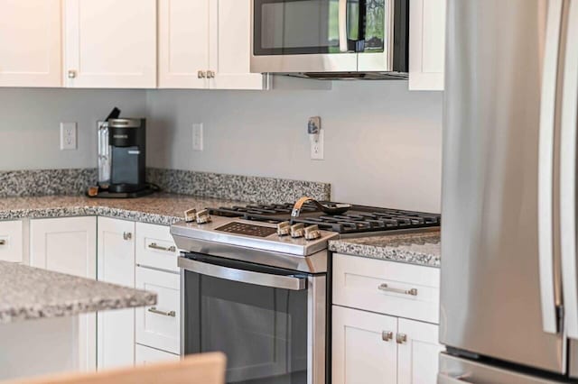 10 Haleys Ct Unit 22, Wells, ME 04090 - kitchen featuring appliances with stainless steel finishes, white cabinets, and light stone counters