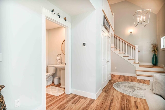 10 Haleys Ct Unit 22, Wells, ME 04090 - hallway featuring light wood-type flooring, stairway, a chandelier, and baseboards