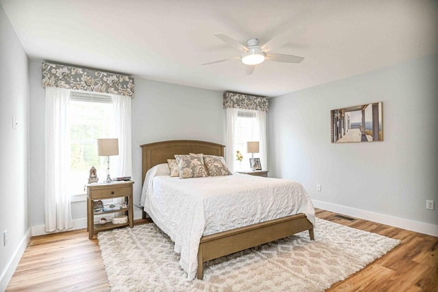 10 Haleys Ct Unit 22, Wells, ME 04090 - bedroom with multiple windows, baseboards, light wood finished floors, and ceiling fan