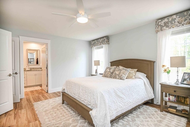 10 Haleys Ct Unit 22, Wells, ME 04090 - bedroom with multiple windows, light wood-style floors, ensuite bathroom, and a ceiling fan