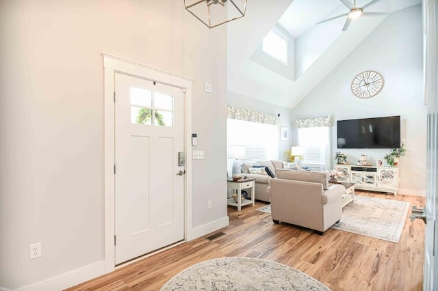 10 Haleys Ct Unit 22, Wells, ME 04090 - entryway featuring high vaulted ceiling, baseboards, wood finished floors, a skylight, and ceiling fan