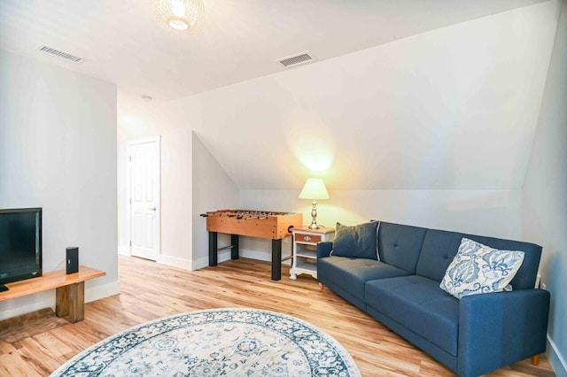 10 Haleys Ct Unit 22, Wells, ME 04090 - living area featuring wood finished floors, vaulted ceiling, and baseboards