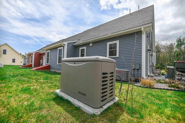 10 Haleys Ct Unit 22, Wells, ME 04090 - rear view of house featuring central air condition unit, a yard, and a shingled roof