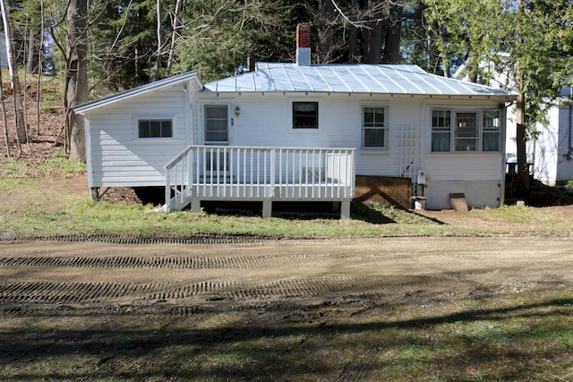 68 Salmon Rd, Madison, ME 04950 - rear view of house with a wooden deck and a chimney