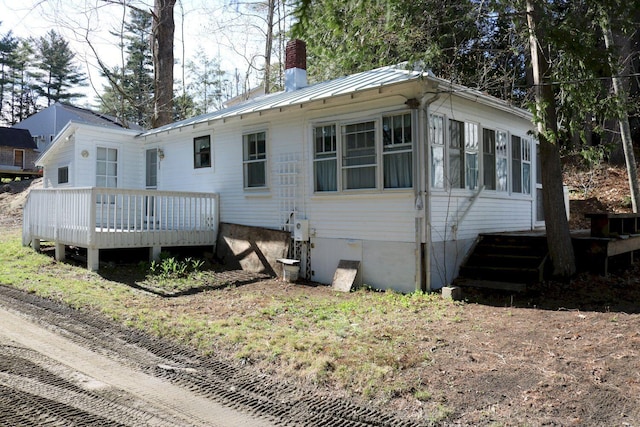 68 Salmon Rd, Madison, ME 04950 - rear view of property with metal roof, a chimney, a deck, and a standing seam roof