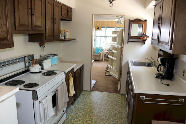 68 Salmon Rd, Madison, ME 04950 - kitchen featuring white electric stove, light countertops, dark brown cabinetry, and a sink