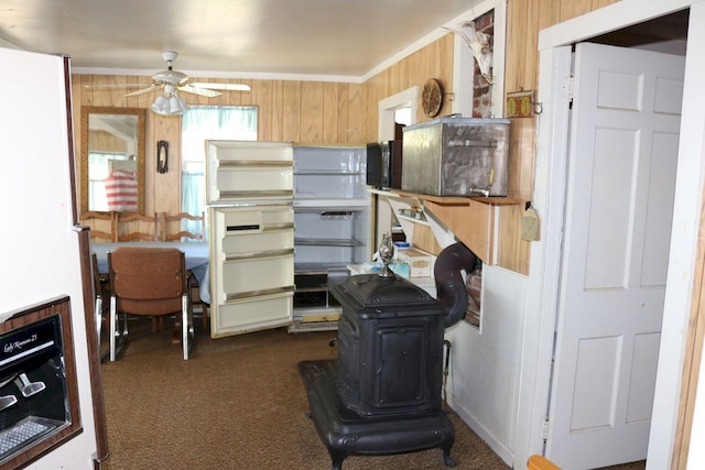 68 Salmon Rd, Madison, ME 04950 - kitchen featuring a ceiling fan, wooden walls, dark colored carpet, and freestanding refrigerator