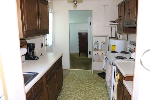 68 Salmon Rd, Madison, ME 04950 - kitchen with white electric range, light countertops, dark brown cabinets, and water heater