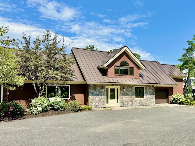 129 Loon Call Dr, Belgrade, ME 04917 - view of front of property with a standing seam roof, stone siding, and an attached garage