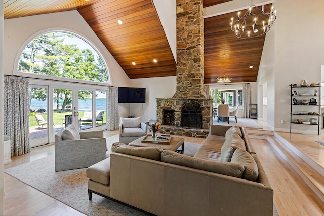 129 Loon Call Dr, Belgrade, ME 04917 - living room featuring wood ceiling, high vaulted ceiling, a chandelier, wood finished floors, and a fireplace