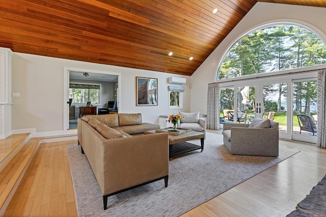 129 Loon Call Dr, Belgrade, ME 04917 - living room featuring high vaulted ceiling, light wood-style flooring, wood ceiling, and a wall mounted AC