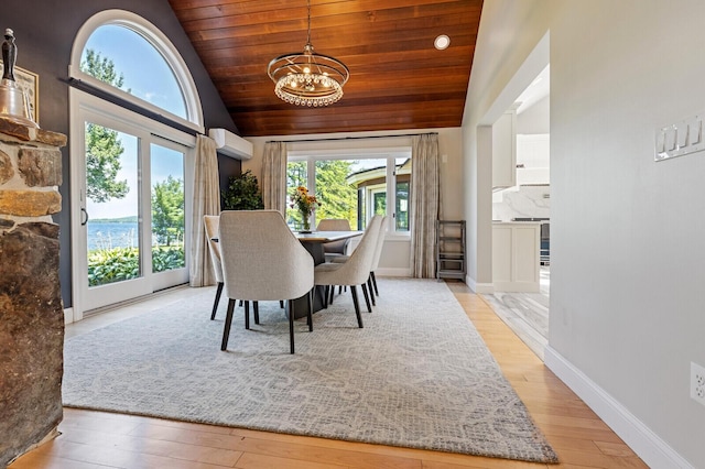129 Loon Call Dr, Belgrade, ME 04917 - dining room featuring a wall mounted AC, wood ceiling, a chandelier, light wood-style floors, and high vaulted ceiling