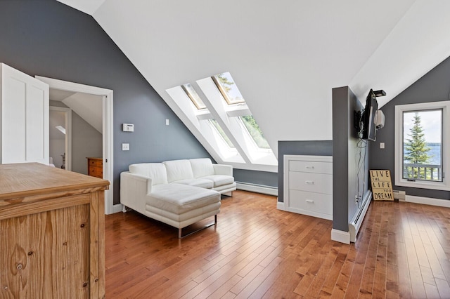 129 Loon Call Dr, Belgrade, ME 04917 - sitting room with a skylight, lofted ceiling, wood-type flooring, a baseboard heating unit, and baseboards