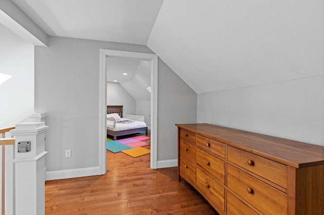 129 Loon Call Dr, Belgrade, ME 04917 - bedroom featuring wood finished floors, vaulted ceiling, and baseboards