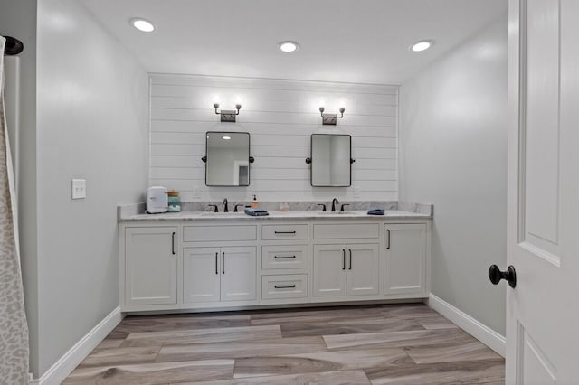 129 Loon Call Dr, Belgrade, ME 04917 - full bathroom featuring double vanity, wood finished floors, baseboards, and recessed lighting