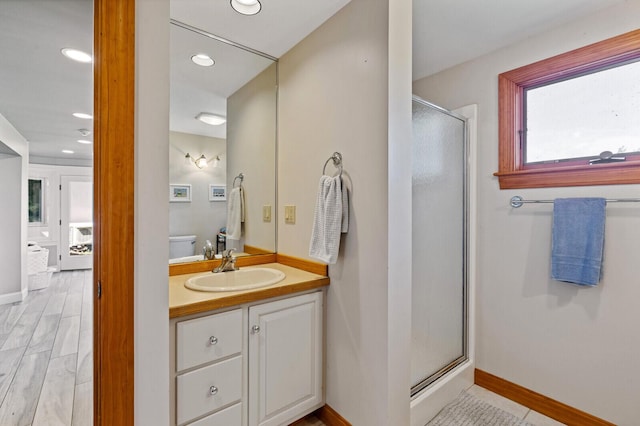 129 Loon Call Dr, Belgrade, ME 04917 - full bath with a shower stall, vanity, baseboards, and recessed lighting