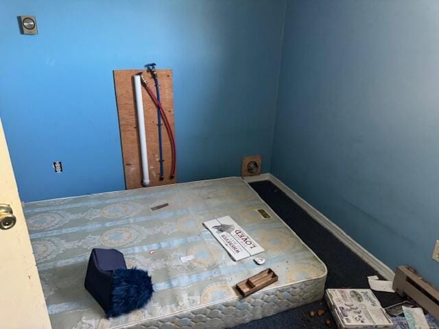 unfurnished room with baseboard heating