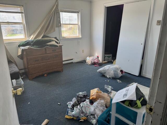 carpeted bedroom with a baseboard radiator