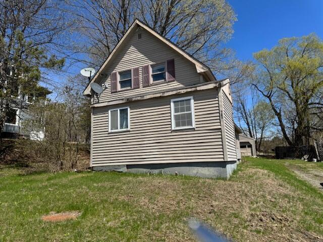 view of side of property with a yard