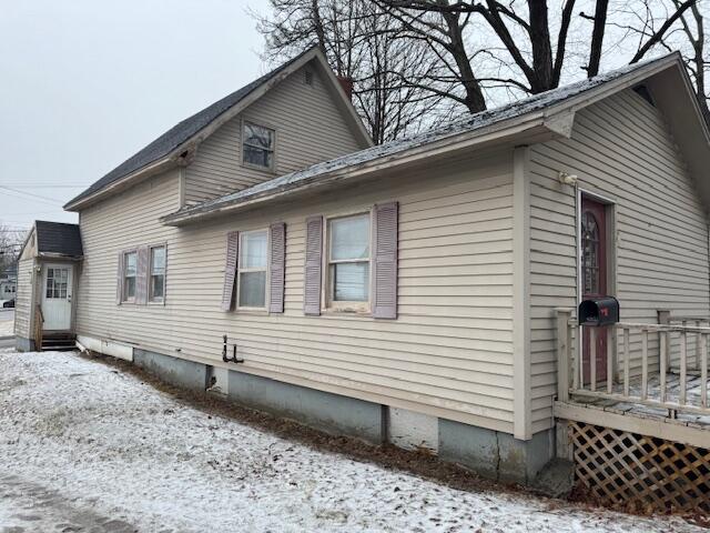 view of home's exterior featuring a deck and entry steps