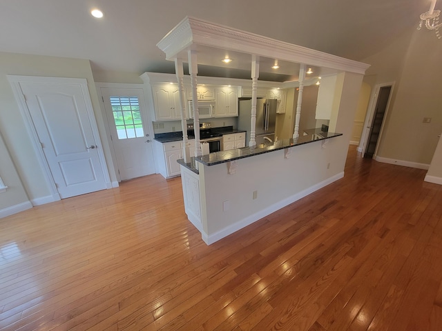 239 Pierce Rd Unit 2B, Brewer, ME 04412 - kitchen with stainless steel appliances, a peninsula, dark countertops, light wood finished floors, and recessed lighting