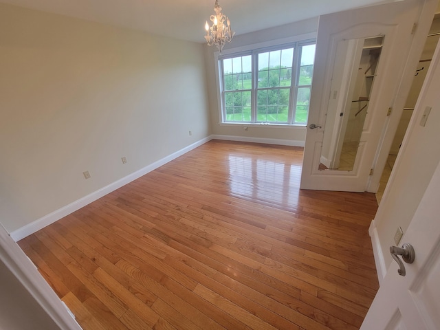 239 Pierce Rd Unit 2B, Brewer, ME 04412 - spare room with light wood-style floors, baseboards, and a chandelier