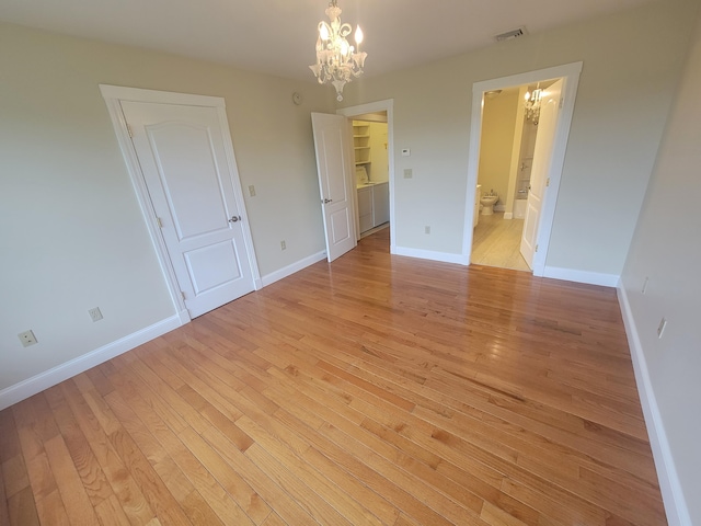 239 Pierce Rd Unit 2B, Brewer, ME 04412 - unfurnished bedroom featuring a chandelier, light wood-type flooring, and baseboards