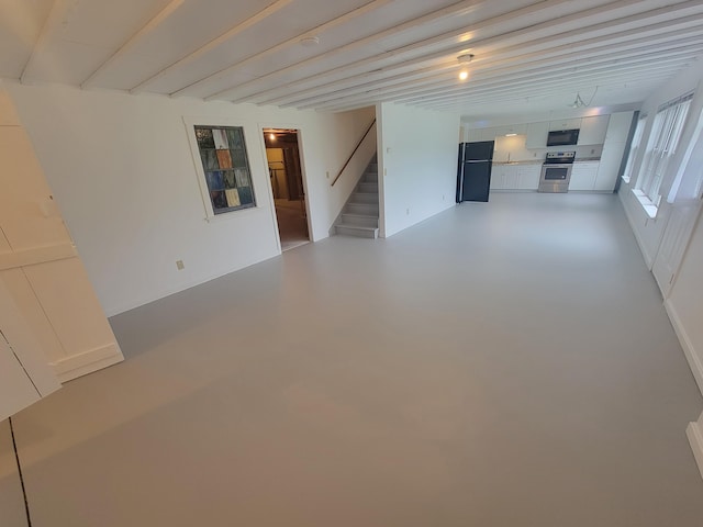 239 Pierce Rd Unit 2B, Brewer, ME 04412 - unfurnished living room featuring stairs, finished concrete flooring, and a sink