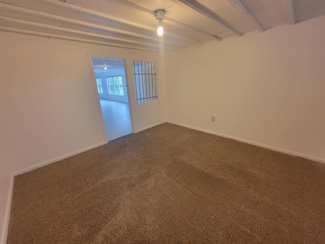 239 Pierce Rd Unit 2B, Brewer, ME 04412 - unfurnished room with dark carpet, baseboards, and beam ceiling