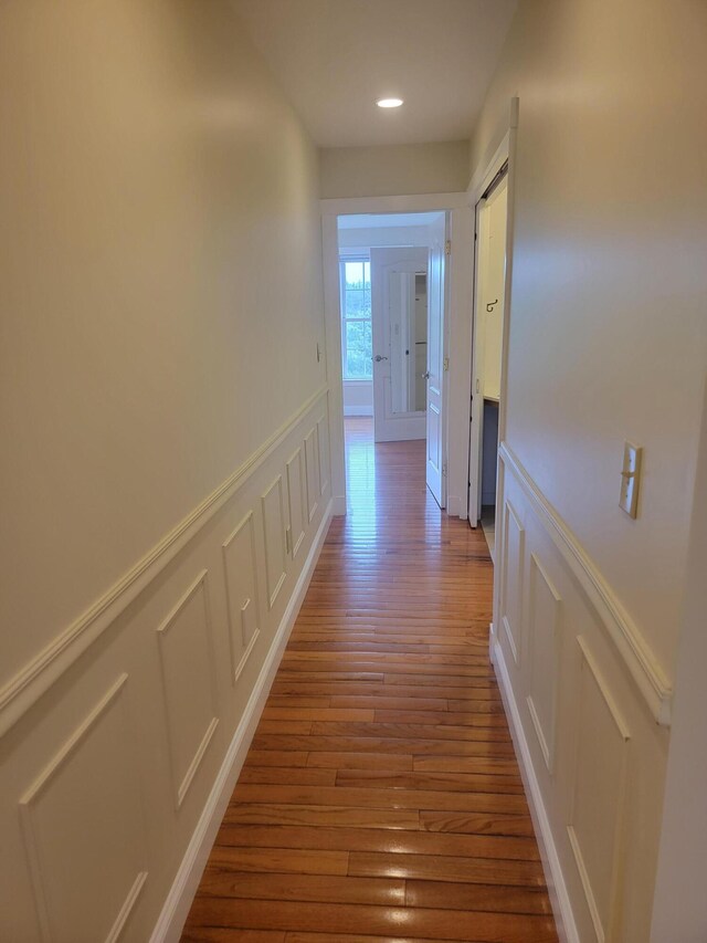 239 Pierce Rd Unit 2B, Brewer, ME 04412 - hall featuring a decorative wall, wood finished floors, wainscoting, and recessed lighting