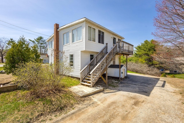 2 Airport Rd, Turner, ME 04282 - back of property with stairs, a chimney, and a deck