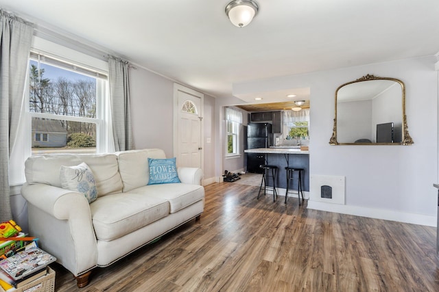 2 Airport Rd, Turner, ME 04282 - living room featuring wood finished floors, baseboards, and plenty of natural light