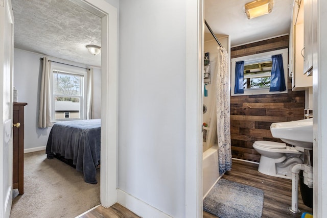 2 Airport Rd, Turner, ME 04282 - bathroom with toilet, wooden walls, wood finished floors, shower / bath combination with curtain, and baseboards