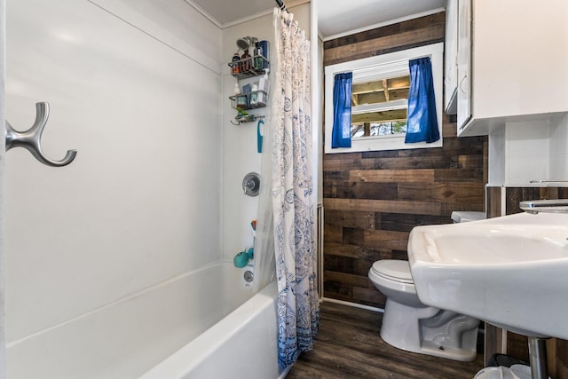 2 Airport Rd, Turner, ME 04282 - full bathroom featuring toilet, wooden walls, wood finished floors, shower / bath combo with shower curtain, and a sink