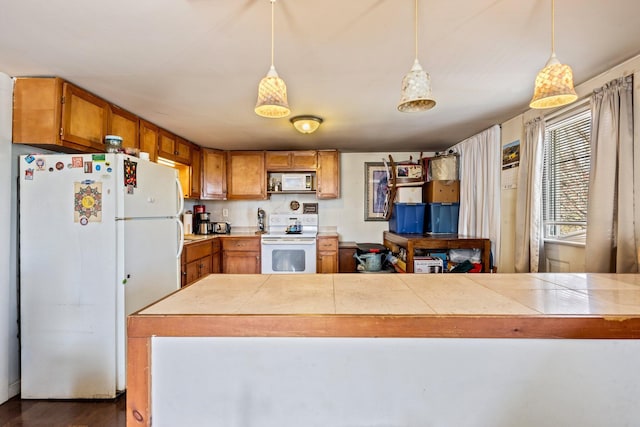2 Airport Rd, Turner, ME 04282 - kitchen featuring white appliances, brown cabinetry, decorative light fixtures, and dark wood-style flooring
