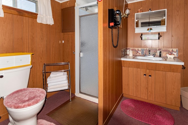full bathroom featuring a stall shower, toilet, wood walls, and vanity