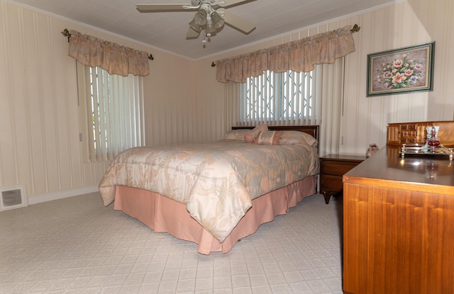 bedroom featuring multiple windows, crown molding, and light colored carpet