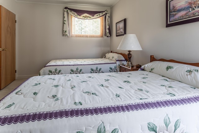 carpeted bedroom featuring ornamental molding