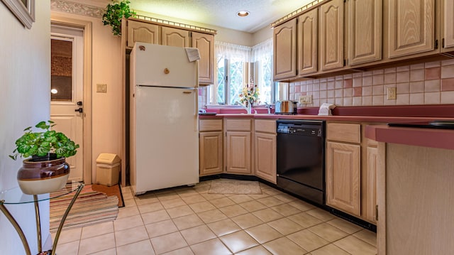 kitchen with freestanding refrigerator, black dishwasher, light tile patterned floors, light brown cabinetry, and a textured ceiling