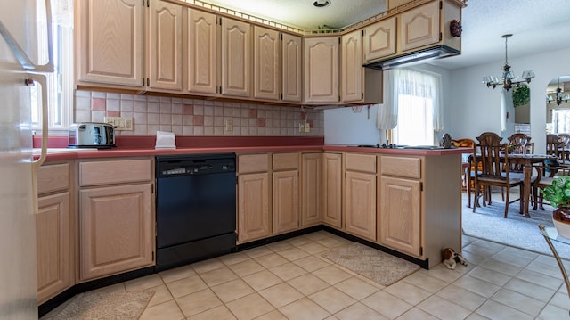 kitchen featuring dishwasher, healthy amount of natural light, a chandelier, and a peninsula