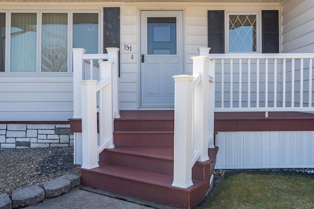 view of exterior entry featuring a porch