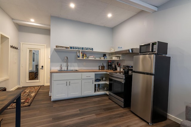 kitchen featuring dark wood-style flooring, a sink, wood counters, ventilation hood, and appliances with stainless steel finishes