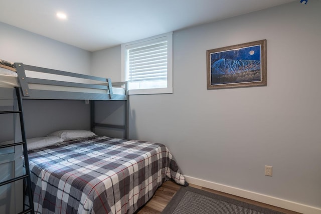 bedroom featuring baseboards and wood finished floors